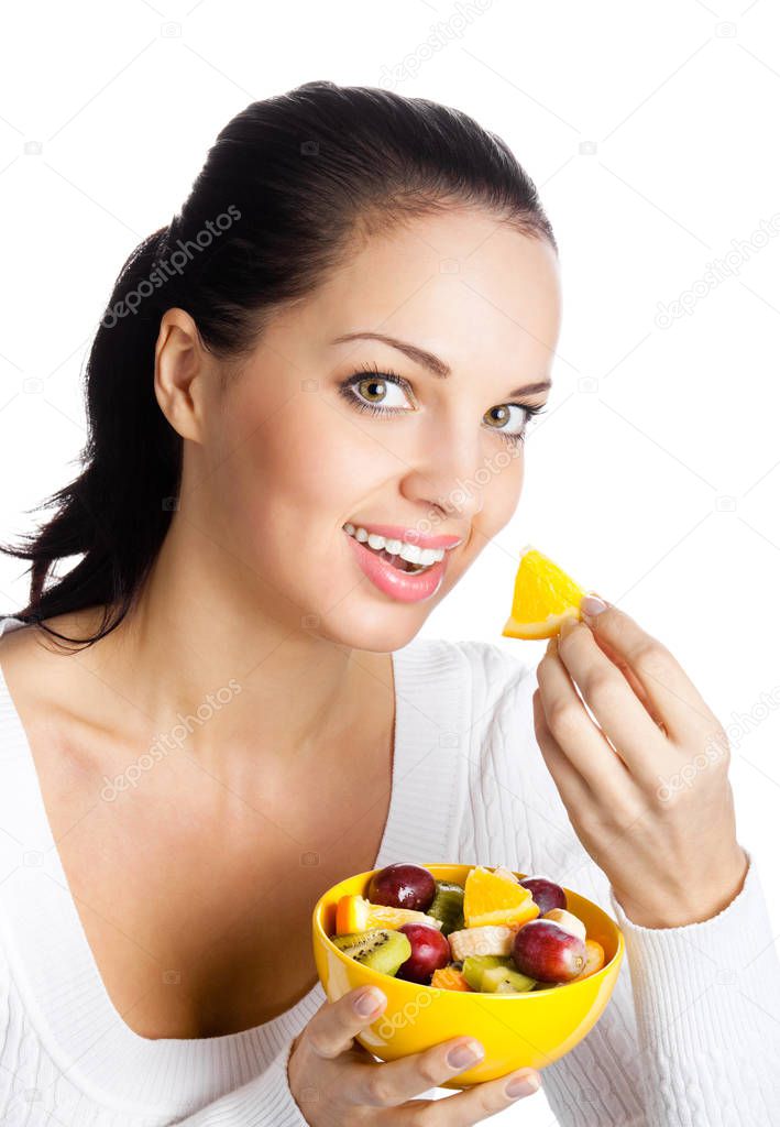 Young smiling woman with bowl of fruits, isolated