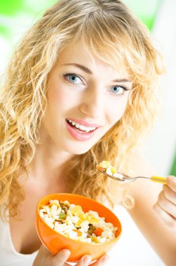 Müsli ya da Mısır gevreği, kapalı yemek genç gülümseyen kadın portresi