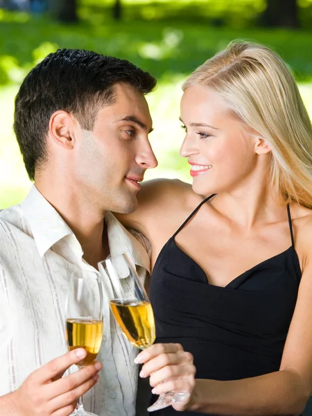 Happy couple celebrating with champagne, outdoors Stock Image