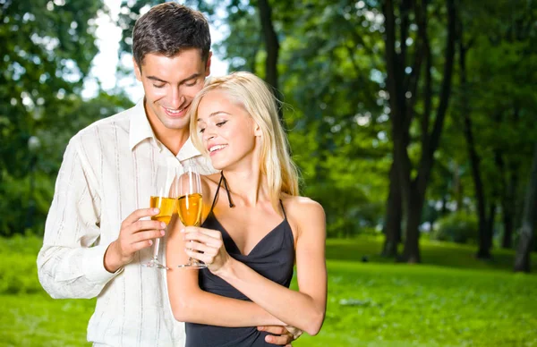 Happy couple celebrating with champagne, outdoors Stock Image