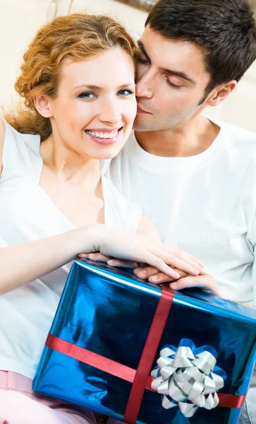 年轻快乐的情侣带着礼物在家里 浪漫的概念拍摄 — 图库照片