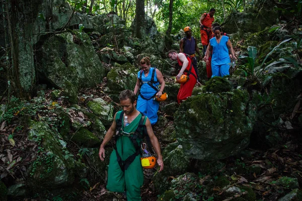 People in outfits hiking through jungle — Stock Photo, Image