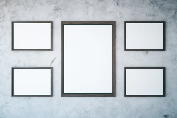 Concrete wall with empty frames — Stock Photo, Image