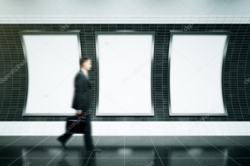 Man walking in front of posters