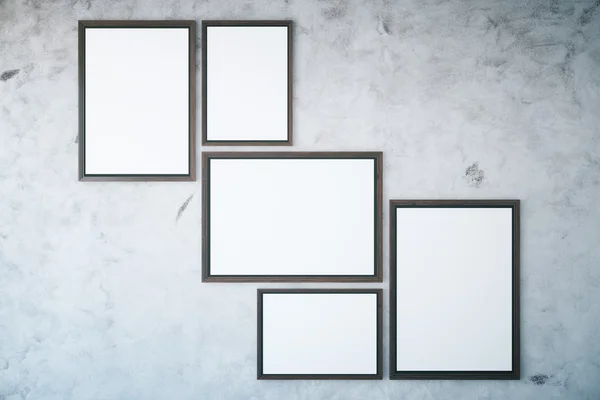 Concrete wall with empty frames — Stock Photo, Image