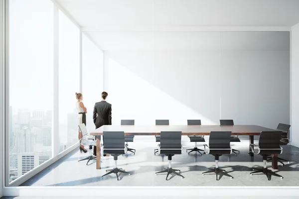 Businessman and woman in conference room — Stock Photo, Image