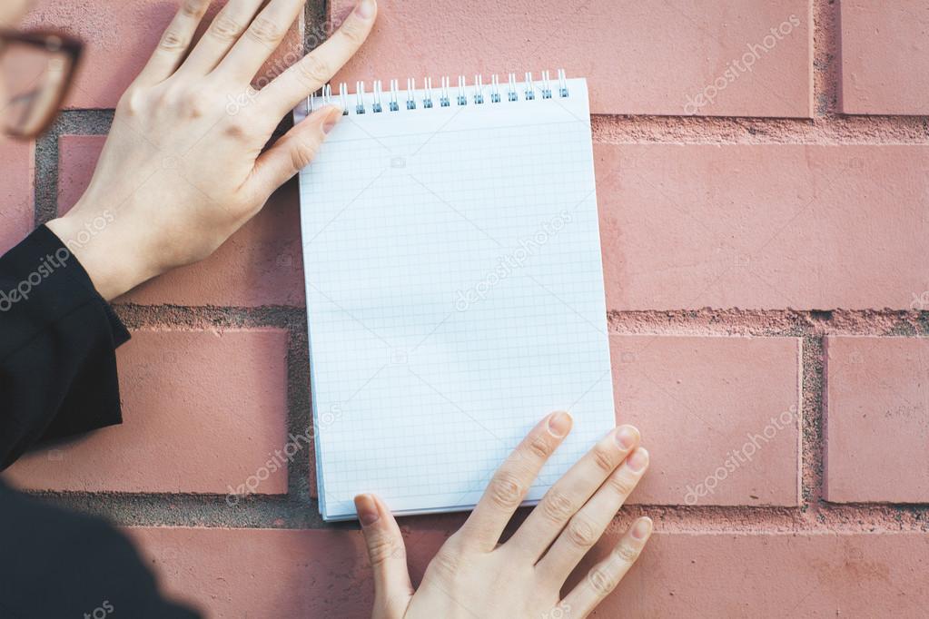 Woman holding spiral notepad