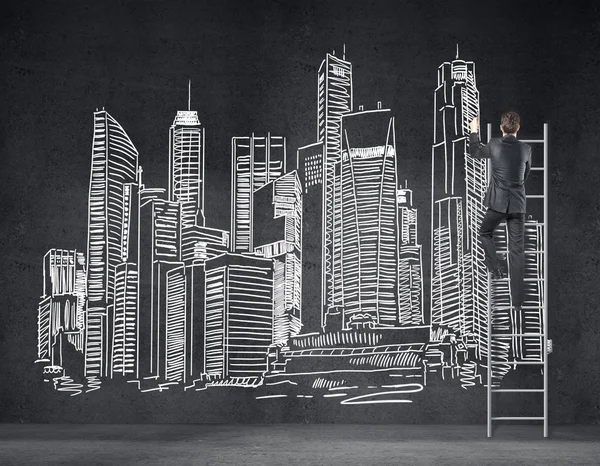 Businessman drawing city — Stock Photo, Image