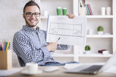 Young architect with construction project