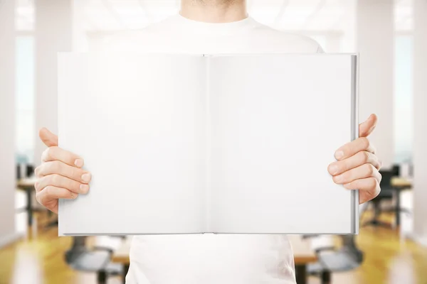 Guy holding open book