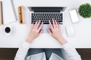 Woman typing on keypad topview