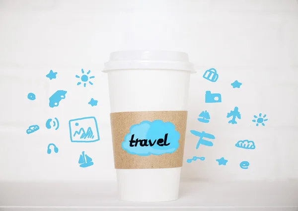 Close up of take away coffee cup with creative blue travel icons on blurry brick background. Traveling concept — Stock Photo, Image