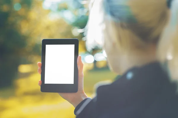 Woman holding white tablet