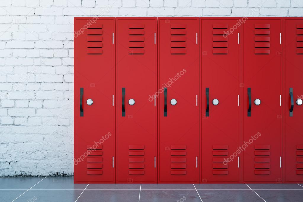 Close up of red lockers in school corridor with white brick walls and