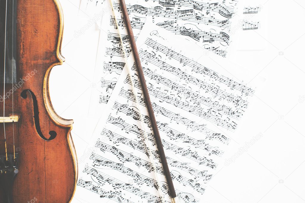 Violin and bow on sheet music background. Music concept Stock Photo by  ©peshkova 127224410