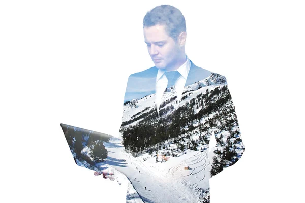 Handsome young businessman using laptop on abstract snowy landscape background. Double exposure. Communication concept — Stock Photo, Image