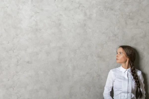 Pretty woman on concrete background — Stock Photo, Image