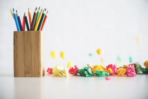 Pencil holder on messy table — Stock Photo, Image