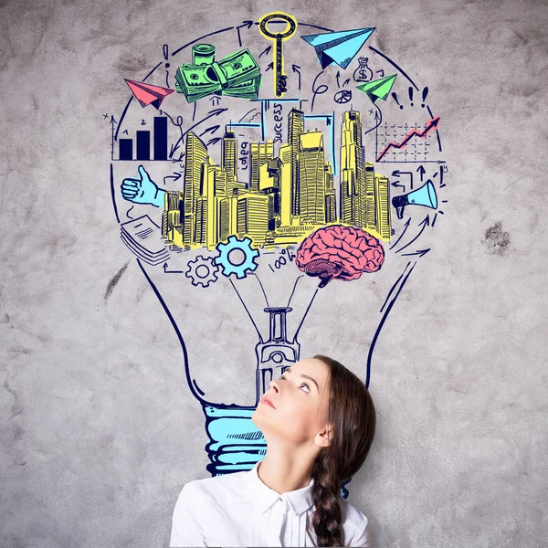 Businesswoman with lightbulb sketch — Stock Photo, Image