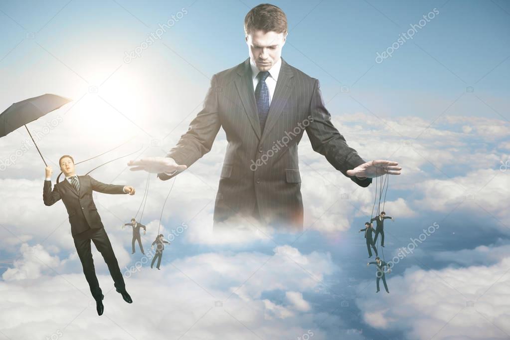 Pensive young businessman manipulating subordinates on sky background with sunlight. Control concept