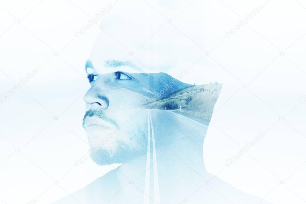 Side portrait of handsome young man on abstract blue landscape background. Thoughts concept. Double exposure