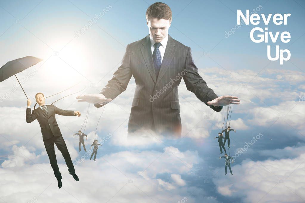 Pensive young businessman controlling subordinates on sky background with sunlight. Manipulation concept