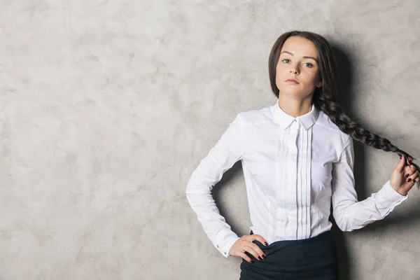 Attractive girl on concrete background — Stock Photo, Image