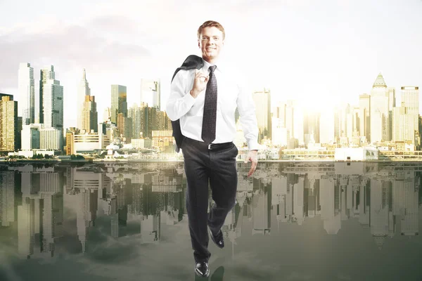 Businessman walking on city background — Stock Photo, Image