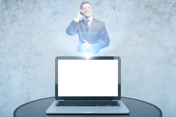 Closeup of small table with blank white laptop and man on phone hologram. Mock up, 3D Rendering. Technology concept — Stock Photo, Image