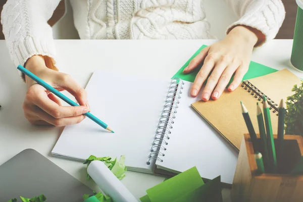 Woman writing in spiral notepad closeup — Stock Photo, Image