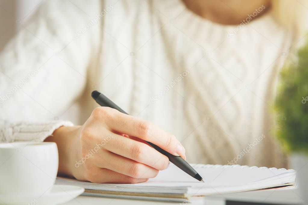 Girl writing in notepad