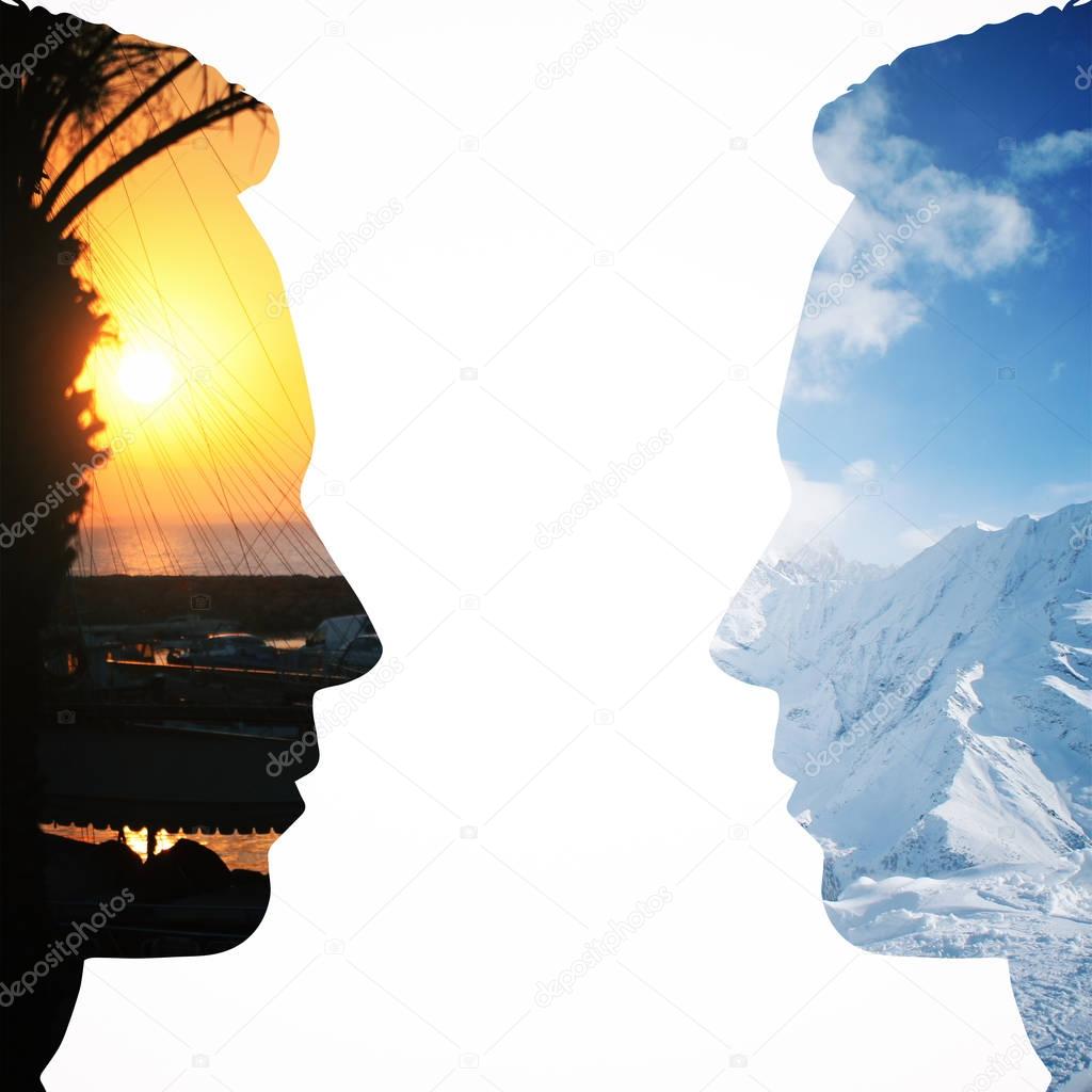 Two male head silhouettes facing each other on vacation city and snowy mountains background. Communication concept. Double exposure
