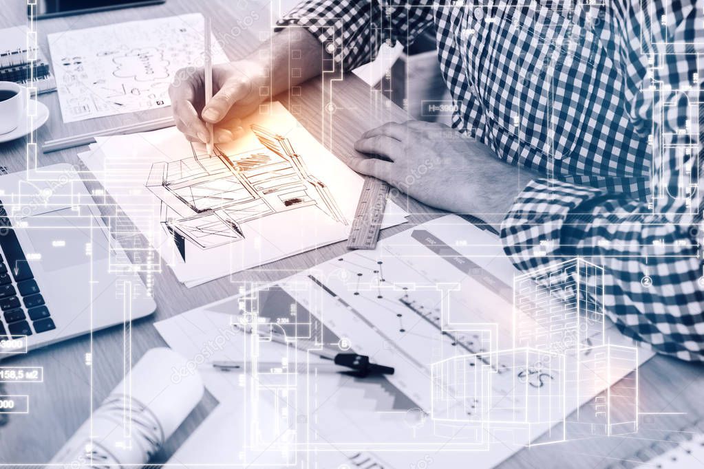 Young architect drawing construction sketch at workplace. Engineering concept