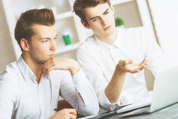 Teamwork concept. Portrait of two attractive european men working on project in modern office. — Stock Photo, Image