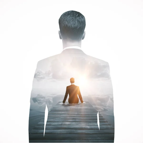 Back view of thoughtful businessperson sitting on pier and looking into the distance. Research concept. Double exposure — Stock Photo, Image