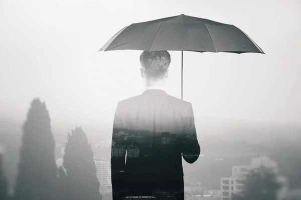 Businessman with umbrella — Stock Photo, Image