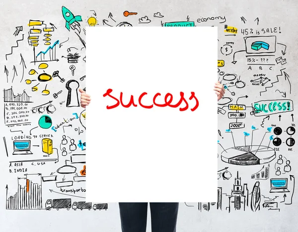 Person holding banner that says success on white background with business sketch — Stock Photo, Image