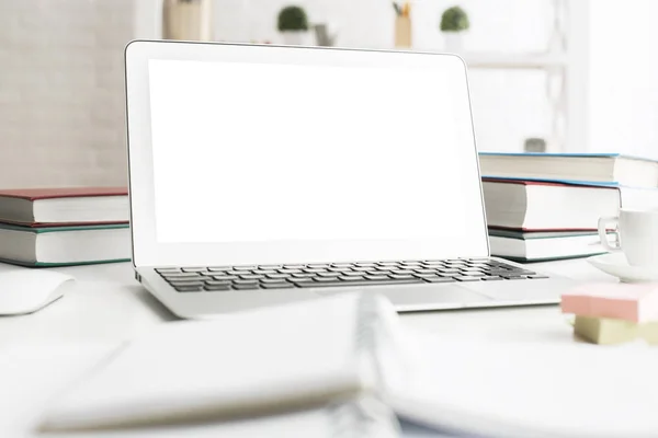 Ακατάστατο γραφείο με λευκό laptop — Φωτογραφία Αρχείου