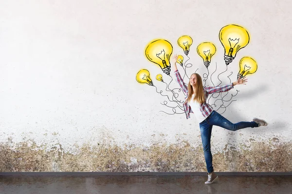 Ragazza felice che balla con palloncini di lampadina astratti in stanze di cemento. Idee di successo — Foto Stock