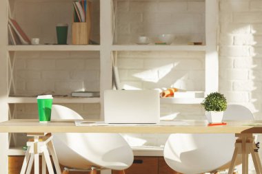 Modern ofis iç raflar öğeler, tablo, diğer öğeleri, ekipman ve güneş ışığı üstünde laptop ile