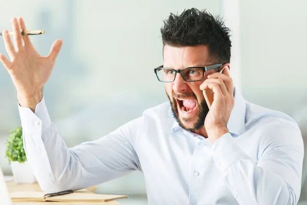 Close up portrait of angry caucasian businessman talking on the phone. Stress concept — Stock Photo, Image