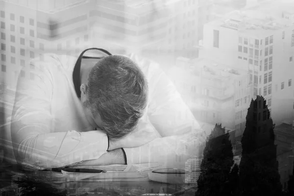 Tired businessman at workplace on abstract city background. Double exposure. Overworked concept — Stock Photo, Image