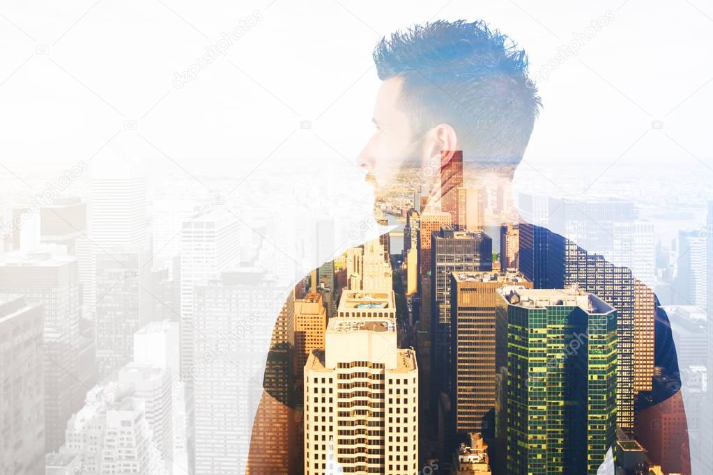 Back view of casual young man on city background. Double exposure. Future concept