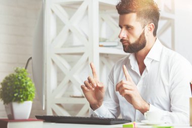 Yan işyerinde parmakları işaret yakışıklı bir adam portresi. Başarı kavramı