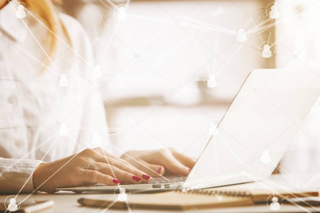 Side view of woman at workplace using laptop with abstract connected staff icons. HR manager concept