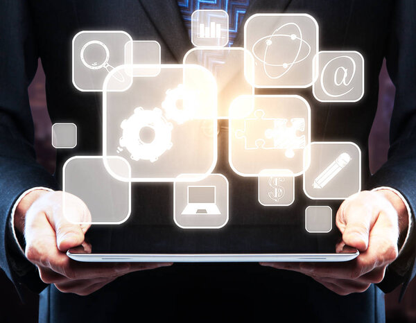 Businessman using tablet with abstract teamwork, research, education and other business icons in cells. Technology concept