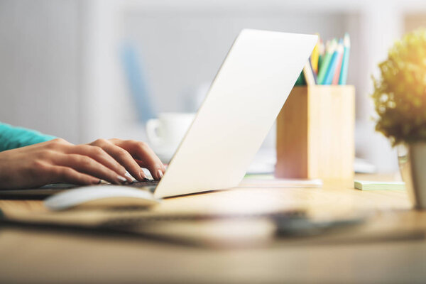 Female hands typing on keyboard