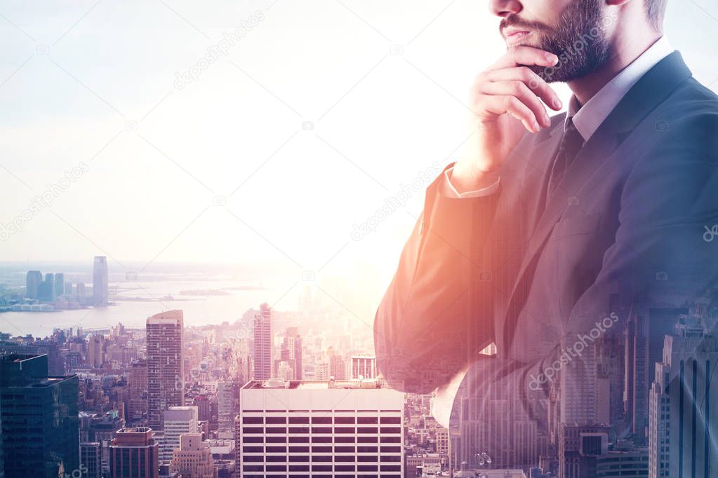 Side view of young euyropean businessman on city background. Research concept. Double exposure