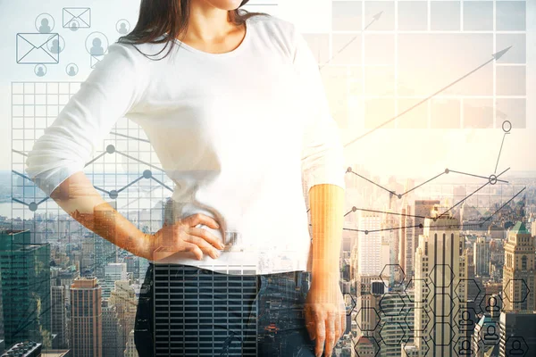 Giovane donna con mano su fianco in piedi su sfondo città creativa con grafici aziendali. Concetto finanziario. Doppia esposizione — Foto Stock