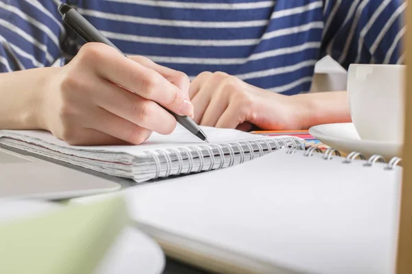 Female writing in copybook — Stock Photo, Image